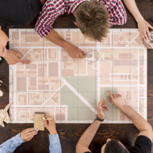 Friends sitting together and planning their travel with a map