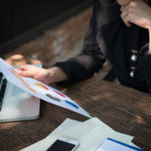business woman working with documents graphs ,analyzing investment chart working in office.